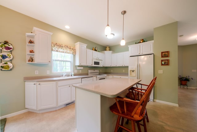 5610 Copper Sands Run, Fruitport, MI 49415 - kitchen with white appliances, a sink, white cabinetry, light countertops, and a breakfast bar