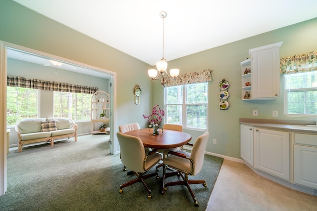5610 Copper Sands Run, Fruitport, MI 49415 - dining room featuring a chandelier, light colored carpet, and baseboards