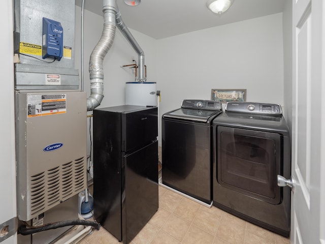 3247 Edling Dr, Kalamazoo, MI 49004 - laundry room featuring separate washer and dryer, light tile patterned floors, and heating unit