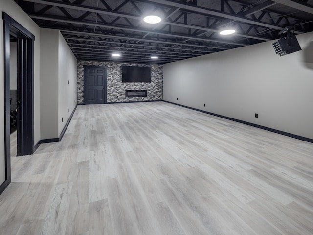 3247 Edling Dr, Kalamazoo, MI 49004 - finished below grade area featuring wood finished floors, a stone fireplace, and baseboards