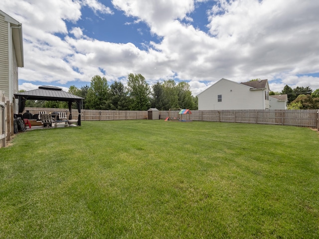 3247 Edling Dr, Kalamazoo, MI 49004 - view of yard featuring a gazebo, a playground, a storage unit, and a patio