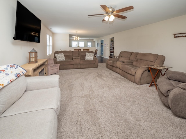 3247 Edling Dr, Kalamazoo, MI 49004 - carpeted living area with ceiling fan and a chandelier