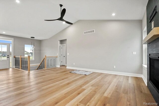 7195 Geraldine Cir, Swartz Creek, MI 48473 - unfurnished living room featuring a fireplace, light wood-type flooring, a ceiling fan, recessed lighting, and high vaulted ceiling