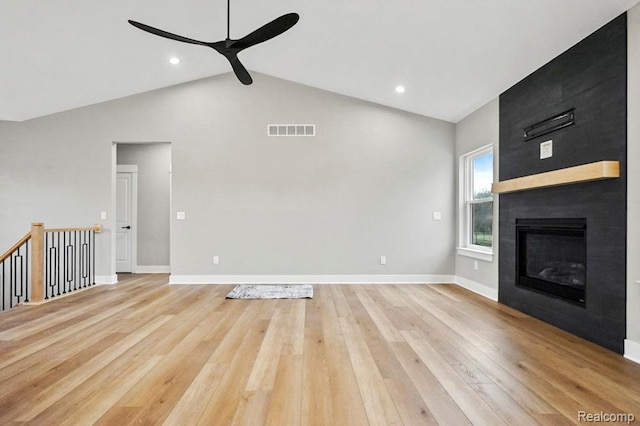 7195 Geraldine Cir, Swartz Creek, MI 48473 - unfurnished living room featuring a ceiling fan, light wood-style floors, baseboards, a fireplace, and high vaulted ceiling
