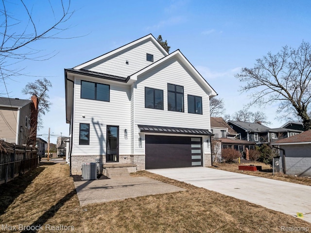 667 Oak Ave, Birmingham, MI 48009 - view of front facade featuring an attached garage, stone siding, central AC, driveway, and a residential view