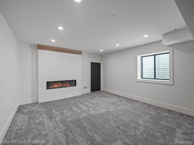 667 Oak Ave, Birmingham, MI 48009 - unfurnished living room featuring a large fireplace, carpet, recessed lighting, and baseboards