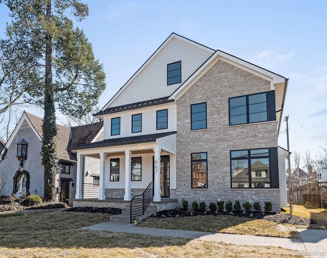 667 Oak Ave, Birmingham, MI 48009 - view of front facade with stone siding, a standing seam roof, a porch, and metal roof