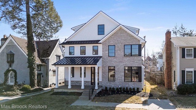 667 Oak Ave, Birmingham, MI 48009 - view of front of house with a standing seam roof, a porch, stone siding, and metal roof