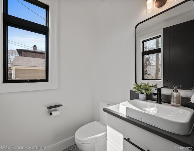667 Oak Ave, Birmingham, MI 48009 - half bath featuring vanity, toilet, and baseboards