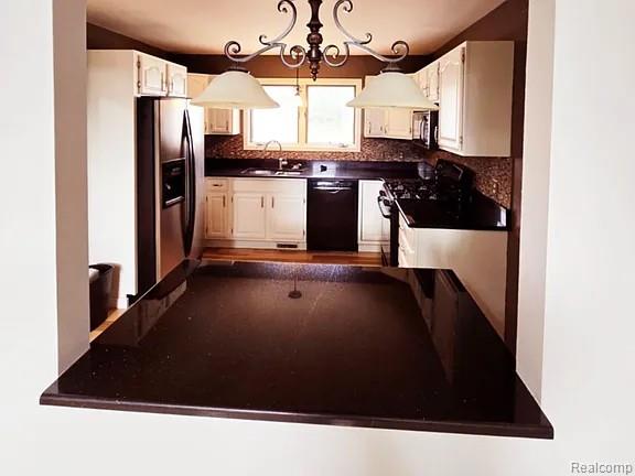 9418 Rayna Dr Unit 62, Davison, MI 48423 - kitchen with stainless steel appliances, a sink, backsplash, and dark countertops