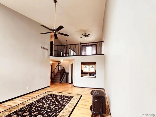 9418 Rayna Dr Unit 62, Davison, MI 48423 - entryway with ceiling fan, stairway, wood finished floors, high vaulted ceiling, and baseboards