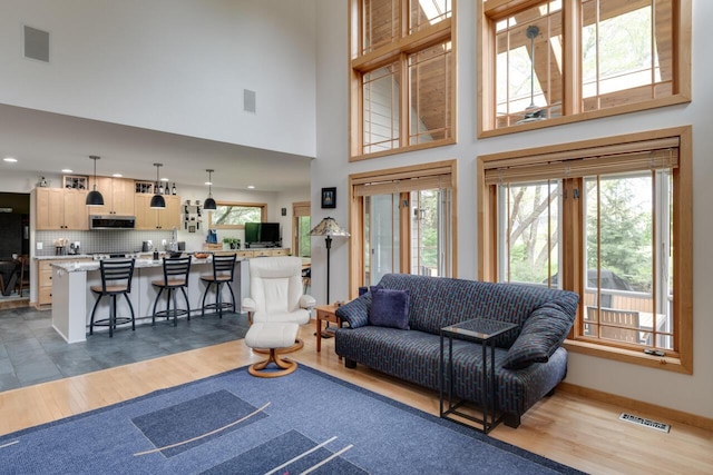 7346 Dunross Dr, Portage, MI 49024 - living room with wood finished floors, recessed lighting, a towering ceiling, and baseboards