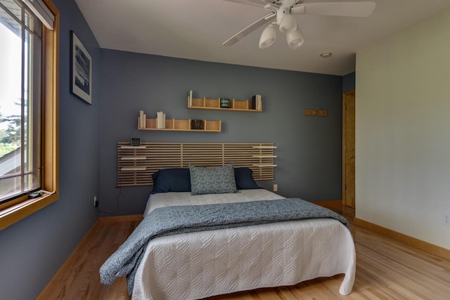 7346 Dunross Dr, Portage, MI 49024 - bedroom featuring wood finished floors, ceiling fan, and baseboards