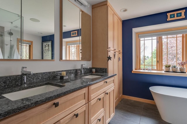 7346 Dunross Dr, Portage, MI 49024 - bathroom featuring a shower stall, double vanity, a freestanding bath, tile patterned flooring, and baseboards