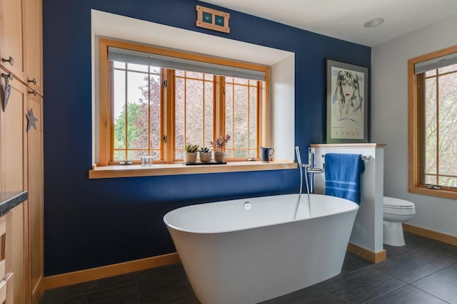 7346 Dunross Dr, Portage, MI 49024 - bathroom featuring a freestanding tub, healthy amount of natural light, and baseboards