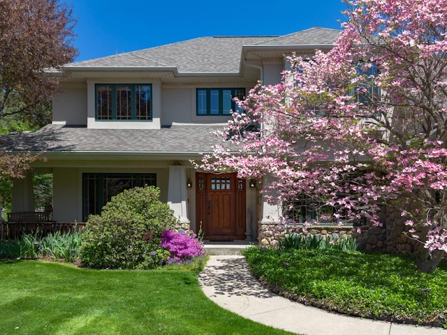 7346 Dunross Dr, Portage, MI 49024 - prairie-style home with stucco siding, a front lawn, and roof with shingles