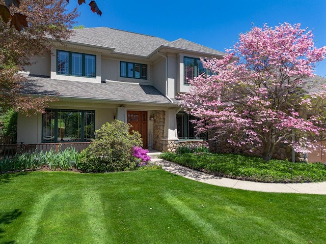 7346 Dunross Dr, Portage, MI 49024 - prairie-style house with stucco siding, a front yard, and stone siding