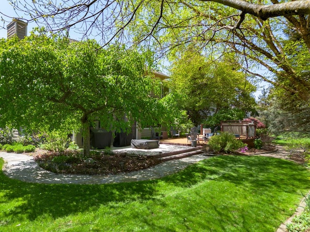 7346 Dunross Dr, Portage, MI 49024 - view of grassy yard with a deck and a patio