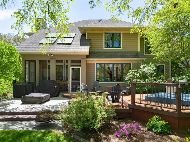 7346 Dunross Dr, Portage, MI 49024 - rear view of property with a deck, roof with shingles, a patio area, and a sunroom