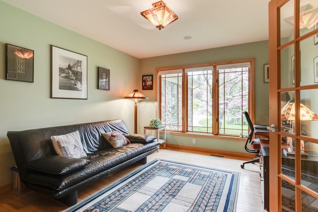 7346 Dunross Dr, Portage, MI 49024 - living room featuring wood finished floors, an office area, and baseboards