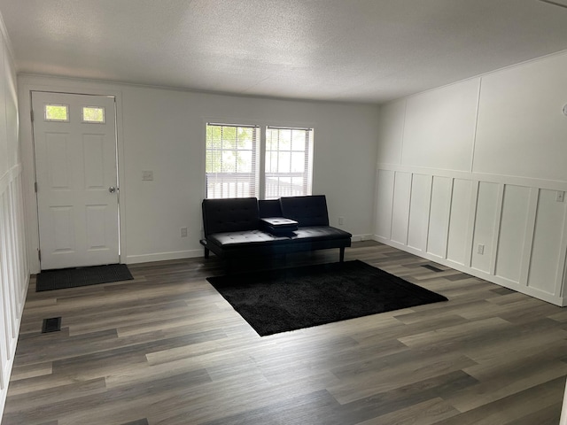 4050 Larkspur Ln, Muskegon, MI 49442 - foyer entrance with wood finished floors, healthy amount of natural light, a textured ceiling, a decorative wall, and baseboards