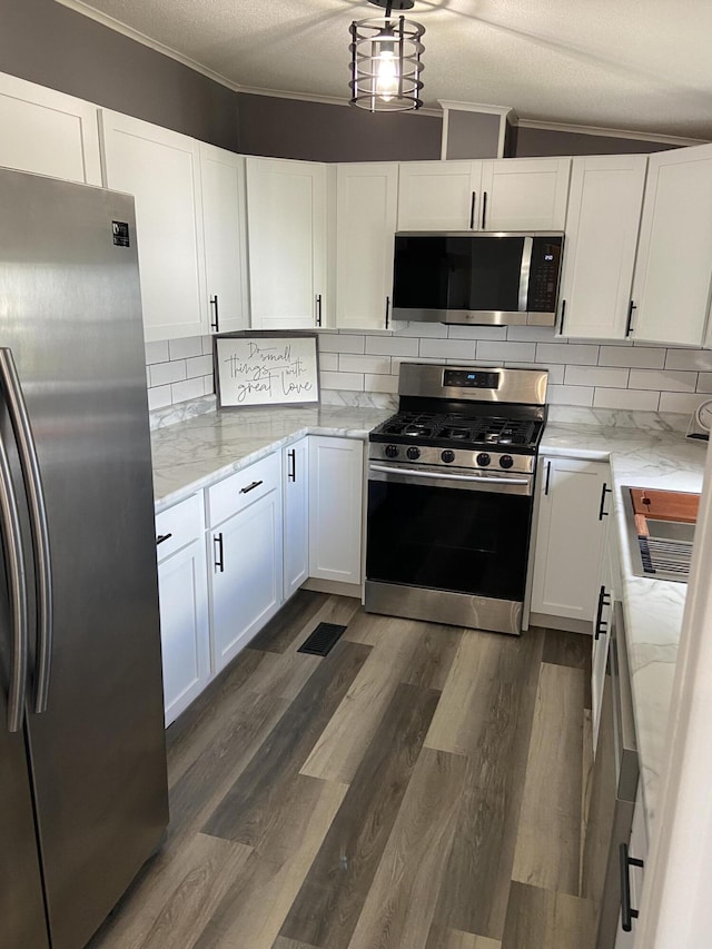4050 Larkspur Ln, Muskegon, MI 49442 - kitchen with stainless steel appliances, white cabinets, dark wood finished floors, and backsplash