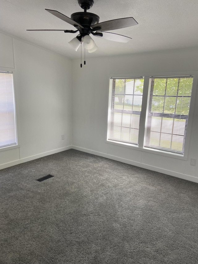 4050 Larkspur Ln, Muskegon, MI 49442 - empty room with a ceiling fan, dark carpet, a textured ceiling, and baseboards