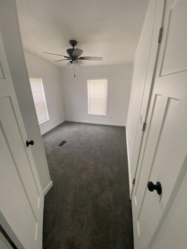4050 Larkspur Ln, Muskegon, MI 49442 - unfurnished bedroom with carpet, multiple windows, and baseboards