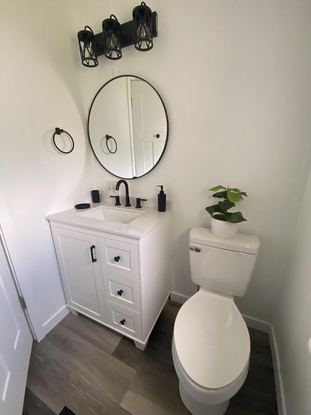 4050 Larkspur Ln, Muskegon, MI 49442 - bathroom with wood finished floors, baseboards, vanity, and toilet