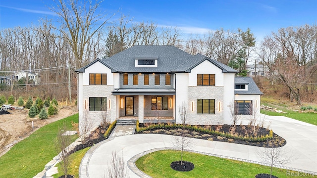 4627 Cimarron Dr, Bloomfield Hills, MI 48302 - view of front of home with curved driveway, covered porch, stucco siding, stone siding, and a front yard