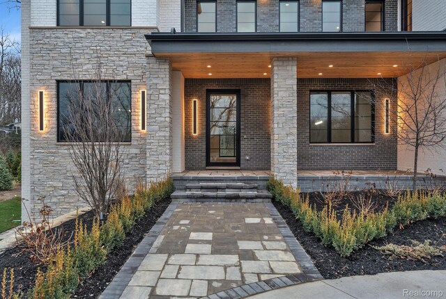 4627 Cimarron Dr, Bloomfield Hills, MI 48302 - entrance to property featuring stone siding, covered porch, and brick siding