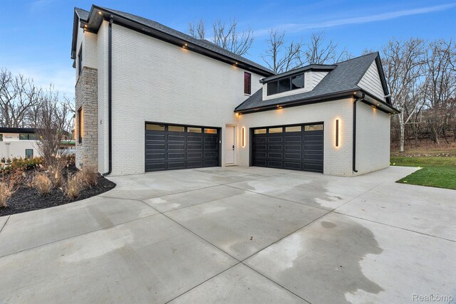 4627 Cimarron Dr, Bloomfield Hills, MI 48302 - view of property exterior with brick siding, concrete driveway, and a garage