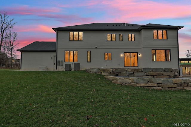 4627 Cimarron Dr, Bloomfield Hills, MI 48302 - back of house at dusk featuring a yard and central air condition unit