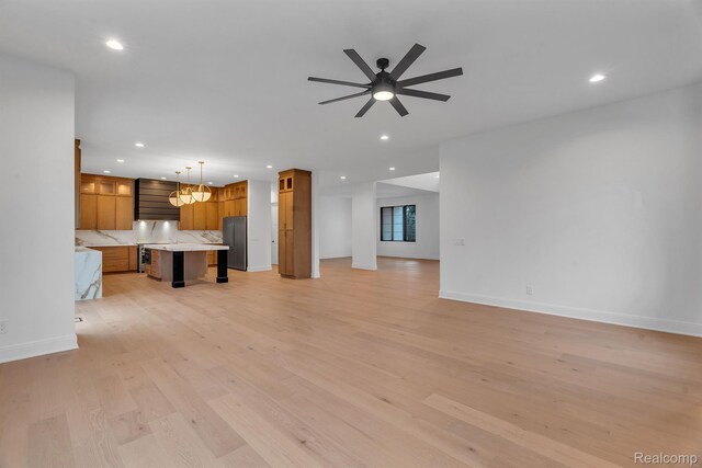 4627 Cimarron Dr, Bloomfield Hills, MI 48302 - unfurnished living room featuring recessed lighting, light wood-type flooring, ceiling fan, baseboards, and a chandelier
