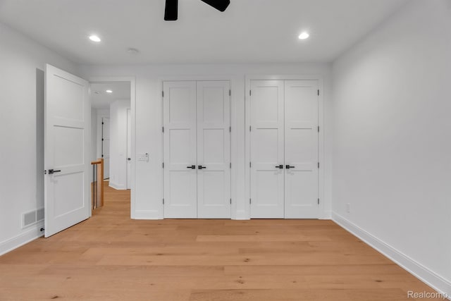 4627 Cimarron Dr, Bloomfield Hills, MI 48302 - unfurnished bedroom with two closets, recessed lighting, light wood-style flooring, baseboards, and a ceiling fan