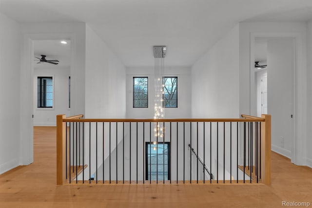 4627 Cimarron Dr, Bloomfield Hills, MI 48302 - hallway with an upstairs landing, wood finished floors, and baseboards