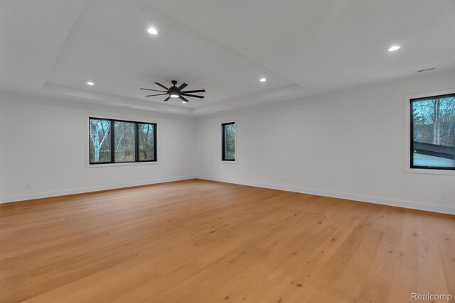 4627 Cimarron Dr, Bloomfield Hills, MI 48302 - spare room with a tray ceiling, healthy amount of natural light, light wood-type flooring, recessed lighting, and baseboards