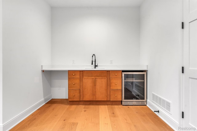 4627 Cimarron Dr, Bloomfield Hills, MI 48302 - indoor bar with wine cooler, light wood-style flooring, and baseboards
