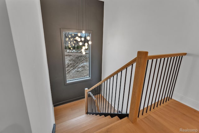 4627 Cimarron Dr, Bloomfield Hills, MI 48302 - stairway with wood finished floors, a chandelier, and baseboards