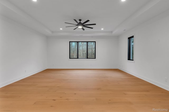 4627 Cimarron Dr, Bloomfield Hills, MI 48302 - spare room with a raised ceiling, recessed lighting, a ceiling fan, light wood-style flooring, and baseboards
