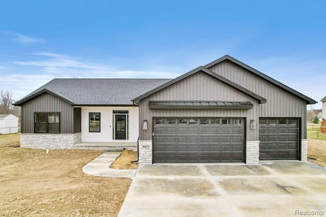 11302 Princewood Cir, Fenton, MI 48430 - modern farmhouse style home with a garage, concrete driveway, a standing seam roof, a shingled roof, and metal roof