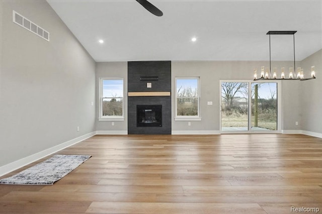 11302 Princewood Cir, Fenton, MI 48430 - unfurnished living room featuring a ceiling fan, light wood-type flooring, baseboards, a fireplace, and lofted ceiling