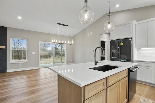 11302 Princewood Cir, Fenton, MI 48430 - kitchen featuring refrigerator with ice dispenser, a sink, lofted ceiling, light countertops, and tasteful backsplash