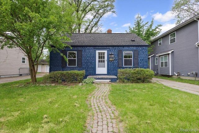 3625 Ellwood Ave, Birmingham, MI 48072 - view of front of home with a front yard, a chimney, and roof with shingles