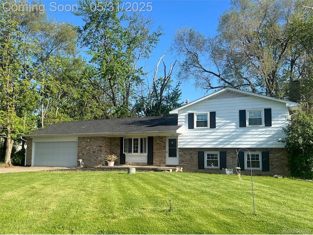 1150 E Hill Rd, Grand Blanc, MI 48439 - tri-level home featuring brick siding, a front lawn, an attached garage, and driveway