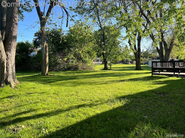 1150 E Hill Rd, Grand Blanc, MI 48439 - view of green lawn with a deck