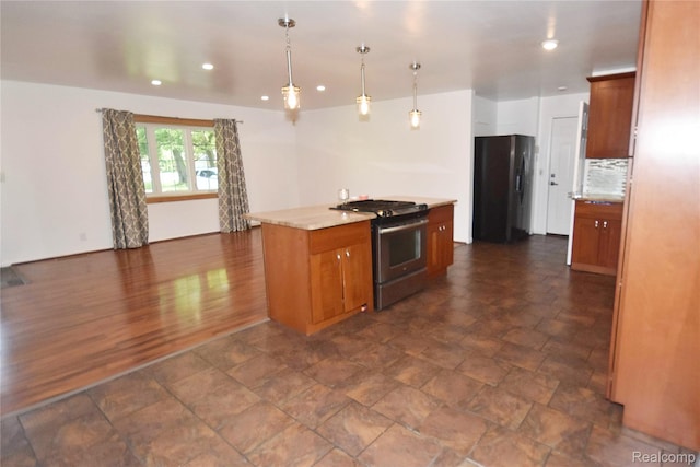 1150 E Hill Rd, Grand Blanc, MI 48439 - kitchen with stainless steel appliances, brown cabinets, recessed lighting, decorative light fixtures, and a center island