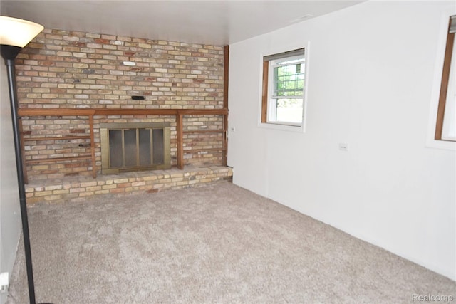 1150 E Hill Rd, Grand Blanc, MI 48439 - unfurnished living room with carpet and a brick fireplace