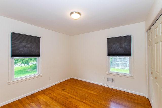 4225 Central Blvd, Ann Arbor, MI 48108 - empty room featuring wood finished floors, plenty of natural light, and baseboards