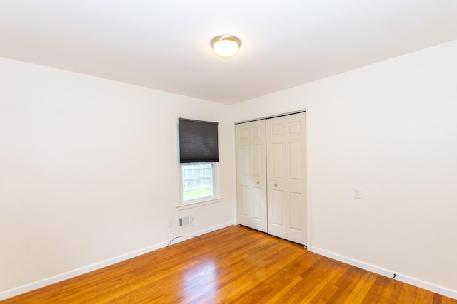 4225 Central Blvd, Ann Arbor, MI 48108 - unfurnished bedroom featuring baseboards, light wood-type flooring, and a closet